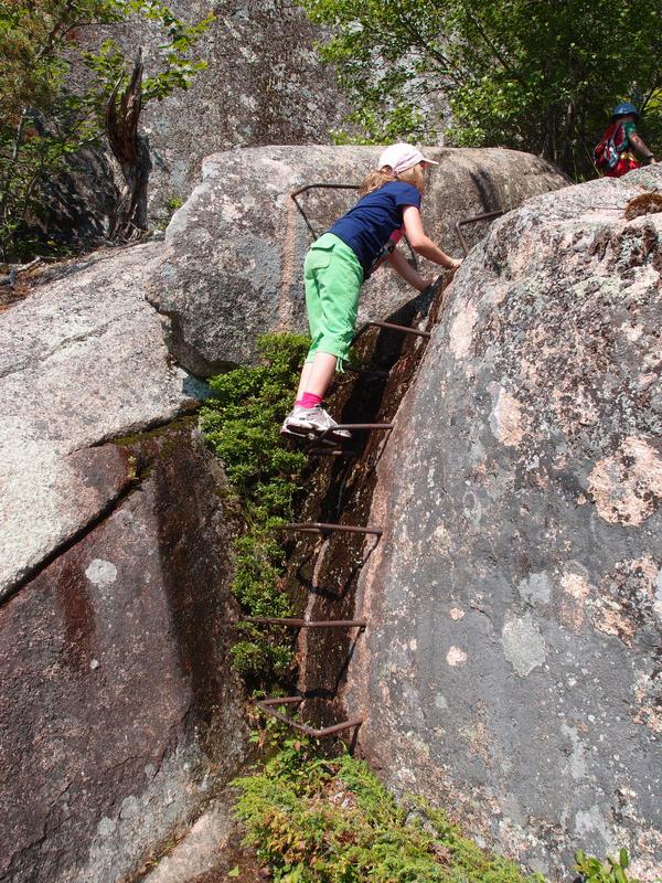 hiker ascending the aptly-named Ladder Trail on the way to Cadillac Mountain at Acadia National Park in Maine