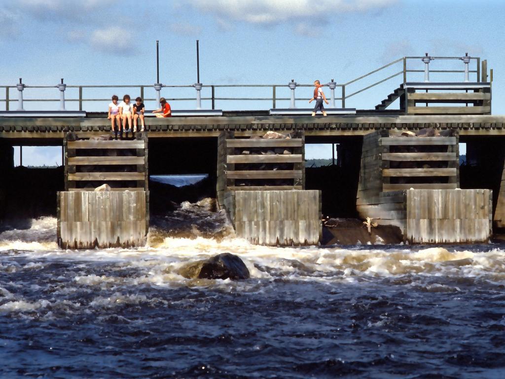 canoeists take a break on the edge of Churchill Dam on the Allagash Wilderness Waterway in northern Maine