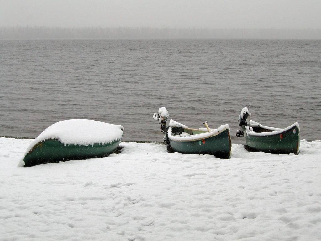 snow-covered canoes in May on the Allagash Wilderness Waterway in northern Maine