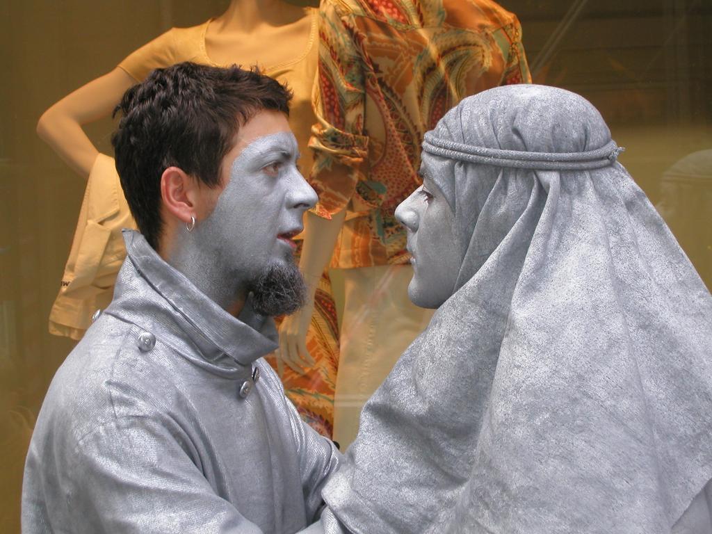 mimes preparing for a statue act on the sidewalk in Saltzburg, Austria