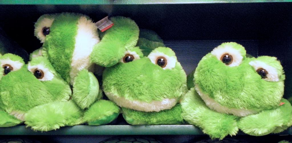 shelf of stuffed frogs