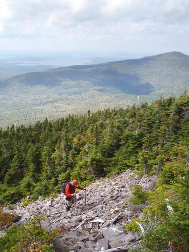 hiker ascending the slide on Baker Mountain in Maine