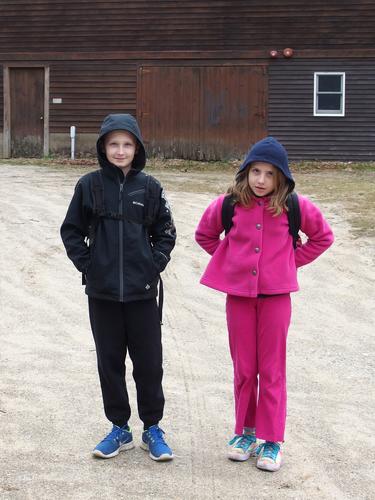 early-Spring hikers by Brown Lane Barn at Beaver Brook in southern New Hampshire