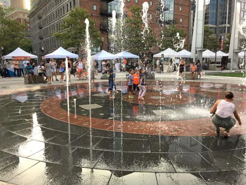 kids enjoy a play fountain near Long Wharf at Boston Harbor in Massachusetts