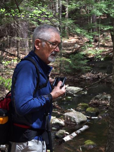 Dick considers a brook photo at Burns Hill in southern New Hampshire