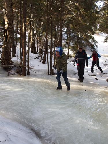 winter hikers on an icy trail to Mount Cardigan in New Hampshire