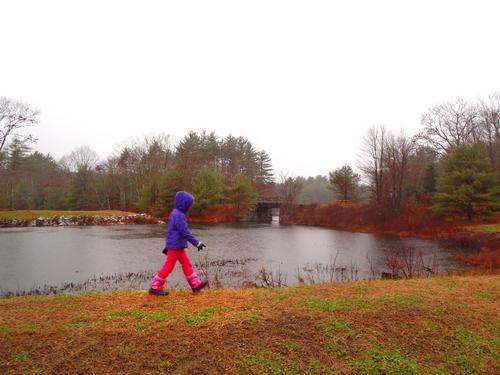 young hiker on the trail around Clark Pond in New Hampshire