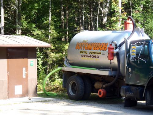 cleaning the outhouse at Welch-Dickey trailhead in New Hampshire