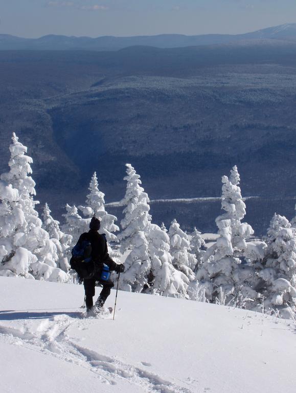 Tom treks across the Skyline Inn's lawn in February atop Equinox Mountain in Vermont