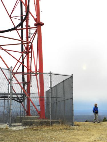 hiker at the summit tower on Fort Mountain in New Hampshire