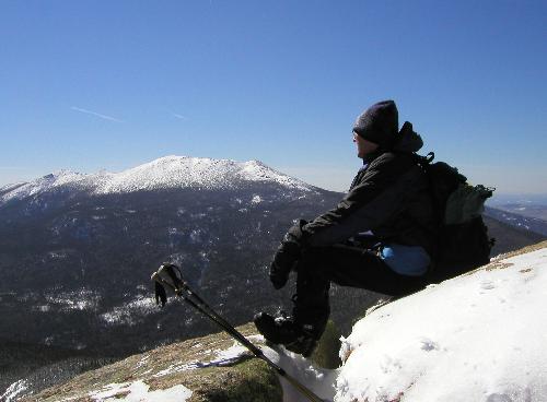 Tom takes in the winter view from atop Mount Garfield with Mount Lafayette in the background in the White Mountains of New Hampshire