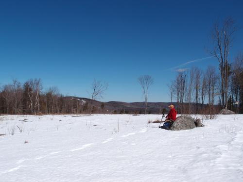 hiker on the summit of Goodhue Hill in New Hampshire