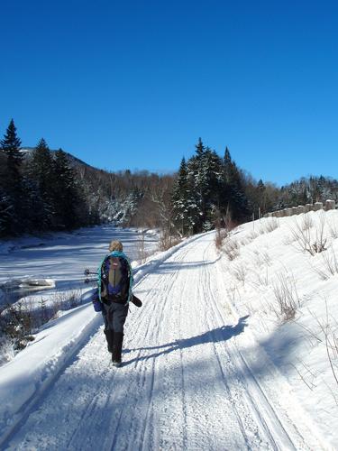 Ann heads up a roadside snomobile trail on the way to Mount Hale in New Hampshire