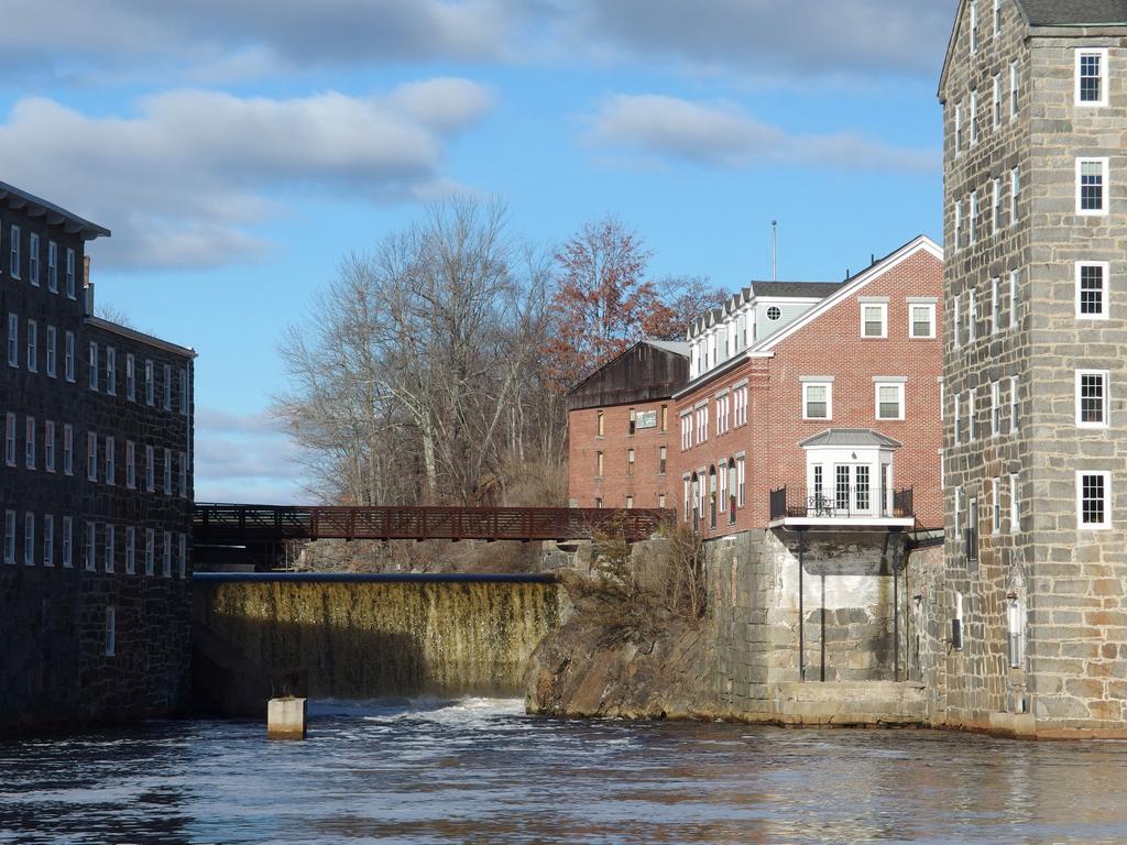 waterfall and mill buildings on the Lamprey River as seen from Heron Point Sanctuary at Newmarket in New Hampshire