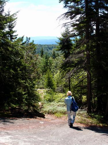 hiker on the way down Hurricane Mountain in New Hampshire