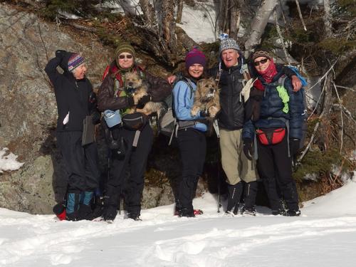 happy hikers on the sunny side of Rays Pond near the summit of Mount Ingalls at Shelburne in New Hampshire