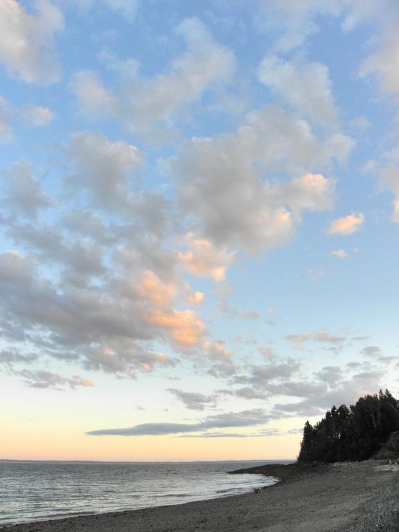 sunset as seen looking up beach toward Gull Point on Islesboro Island in Maine