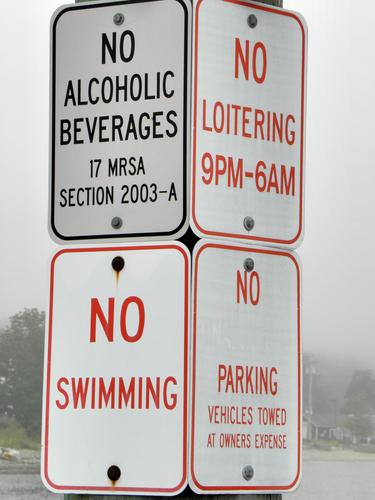 four NO signs on one post at the dock in Lincolnville in Maine