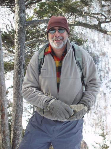 winter hiker on the trail to Mount Jackson in New Hampshire