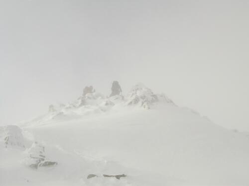 Joni and Mark ascend in December's white-out conditions to the cloud-covered summit of Mount Jefferson in the White Mountains of New Hampshire