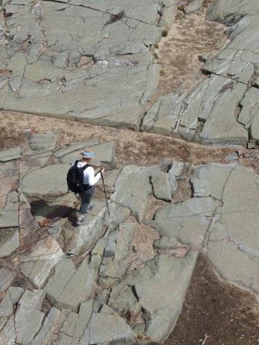 view from the fire tower of Andee traversing summit rock atop Mount Kearsarge in New Hampshire