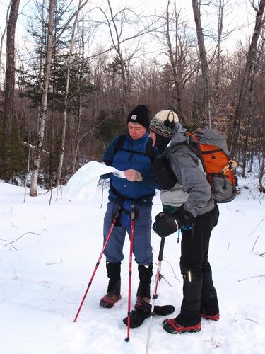 hikers with a map on the way to Kittredge Hill in New Hampshire