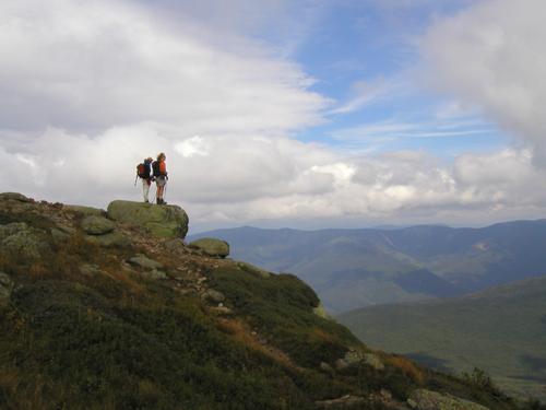 a pair of hikers takes in the stormy view in September on Franconia Ridge in the White Mountains of New Hampshire