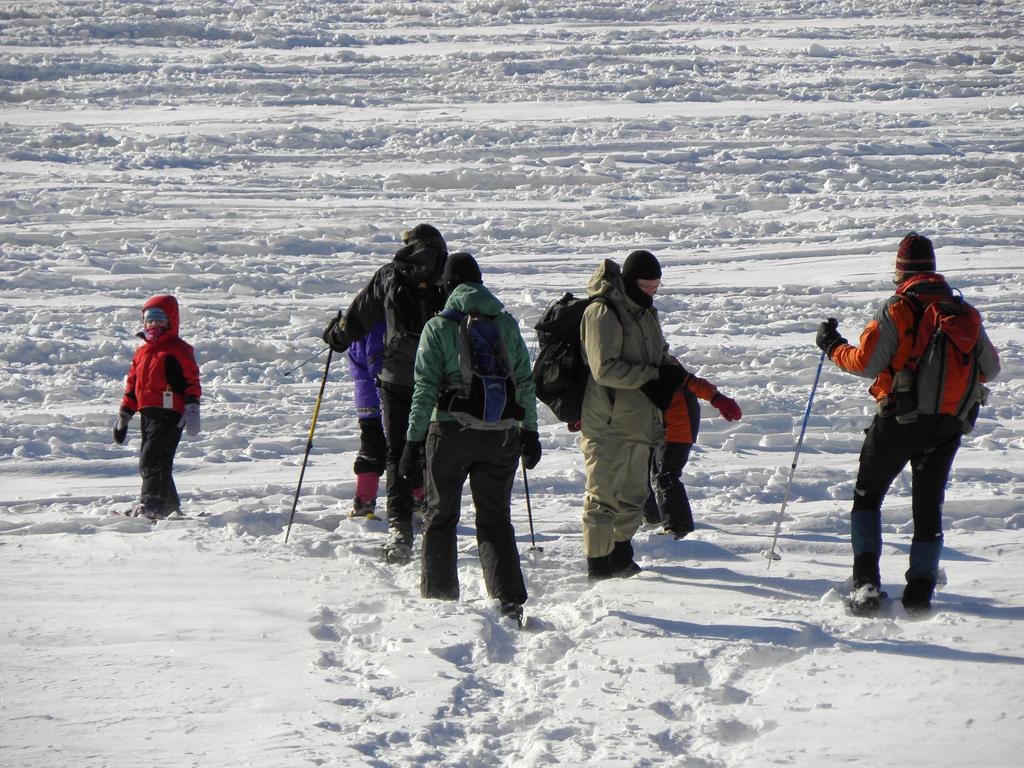 winter hikers on Tower Hill Pond in New Hampshire