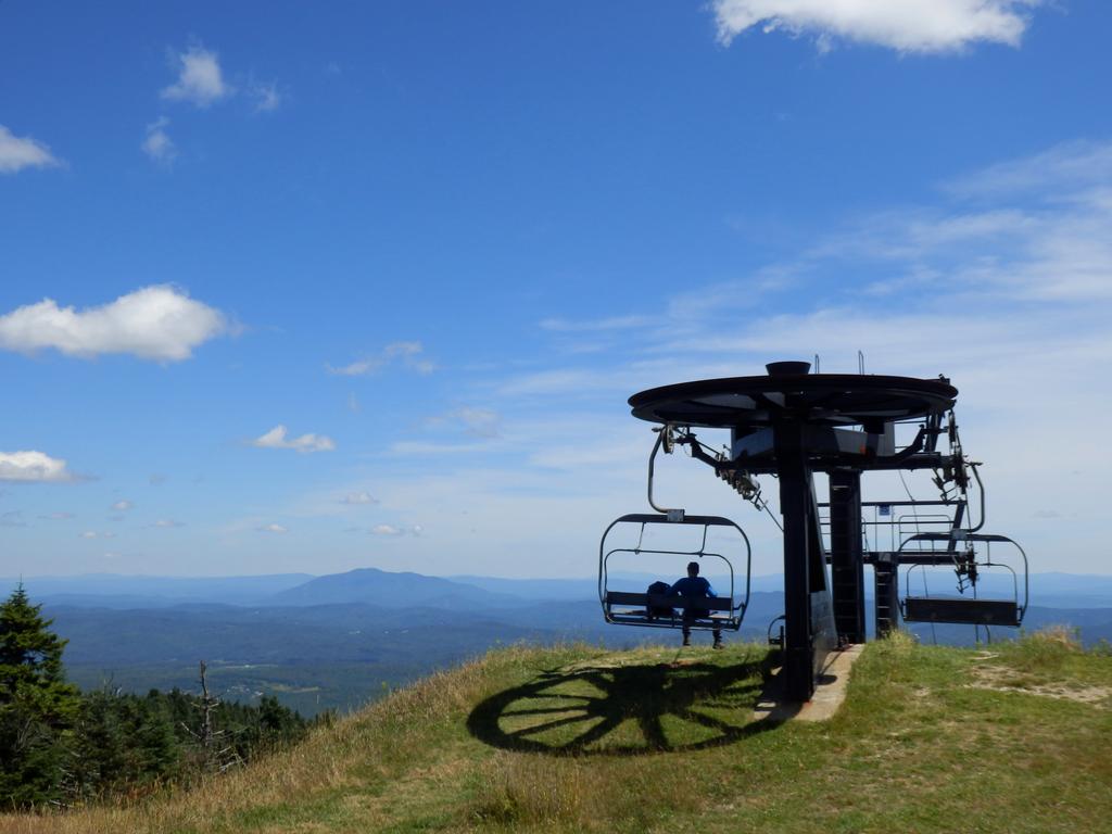 summer hiker enjoying the view from the top of Okemo Mountain in Vermont