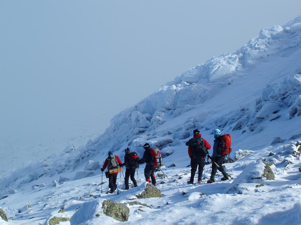 winter hikers head down from the summit of Mount Adams in New Hampshire