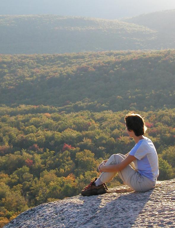 hiker and late-afternoon view from Mount Pemigewasset in New Hampshire