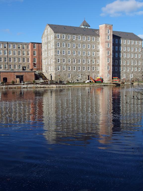 restored mill buildings on the Lamprey River as seen from Heron Point Sanctuary at Newmarket in New Hampshire