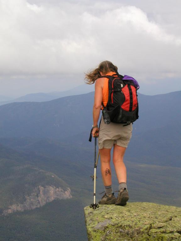 hiker at a scary precipice on Franconia Ridge in New Hampshire