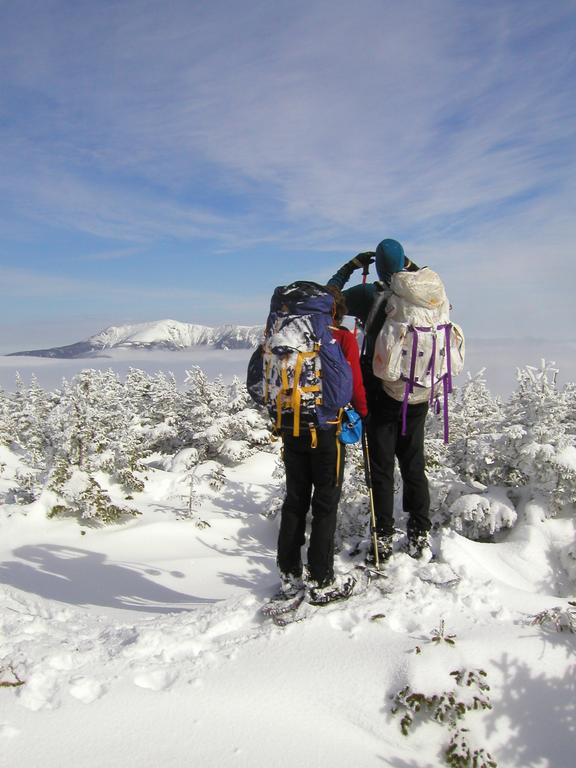 winter view across Franconia Notch with undercast clouds from South Kinsman Mountain in New Hampshire