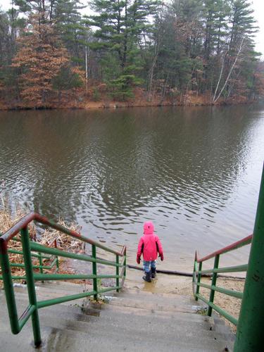 hiker at the beach on Dorrs Pond in New Hampshire