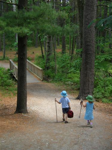 hikers head out on the trail around Dorrs Pond in New Hampshire