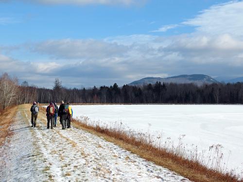 hikers circling Durand Pond on the way to Lookout Ledge in New Hampshire