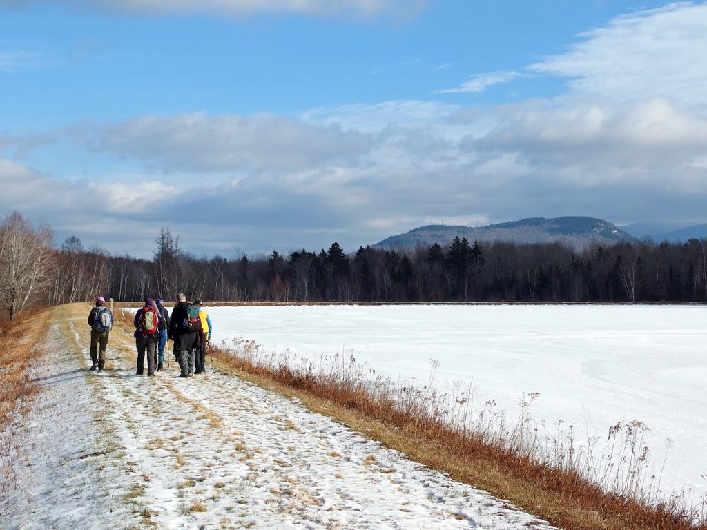 hikers circling Durand Pond on the way to Lookout Ledge in New Hampshire