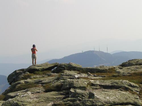 hiker and view from the chin of Mount Manfield's nose in Vermont