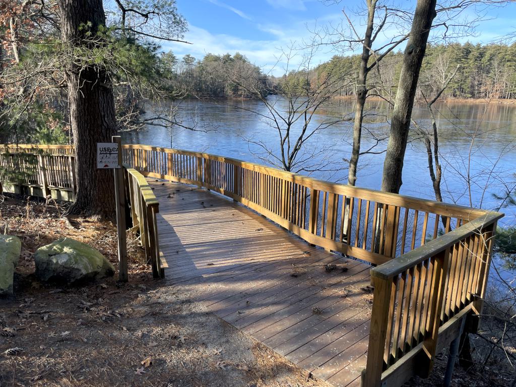 new boardwalk in December circling a projecting edge  of Mill Pond at Mine Falls Park in Nashua NH