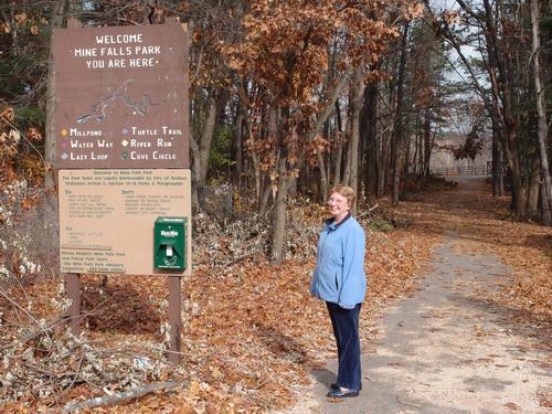 visitor at the 7th Street entrance to Mine Falls Park in New Hampshire