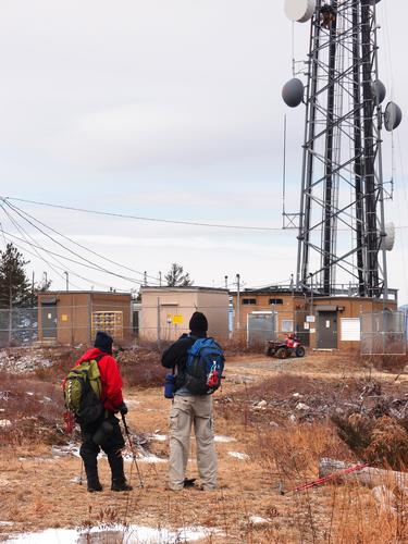 hikers at the communications tower atop Nickerson Mountain in New Hampshire