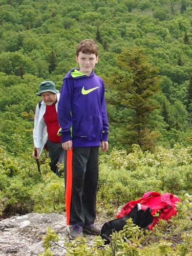 Ryzek pauses at a near-summit viewpoint on The Nubble in New Hampshire