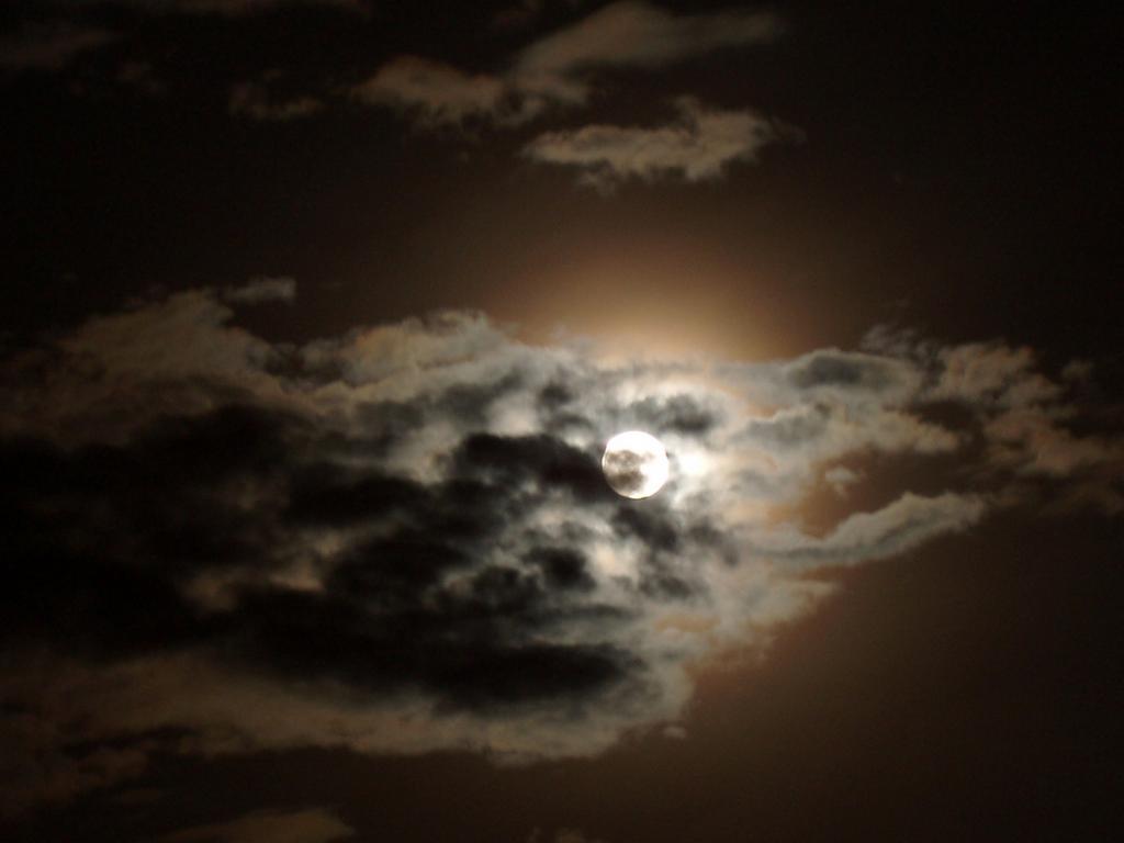 full moon peeking through clouds near South Pack Monadnock Mountain in southern New Hampshire