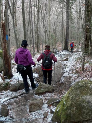 hikers at twilight in November on the trail down from Mount Pemigewasset in New Hampshire