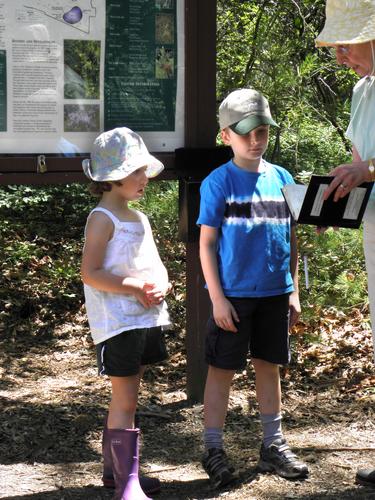 young hikers by the kiosk at Ponemah Bog in New Hampshire