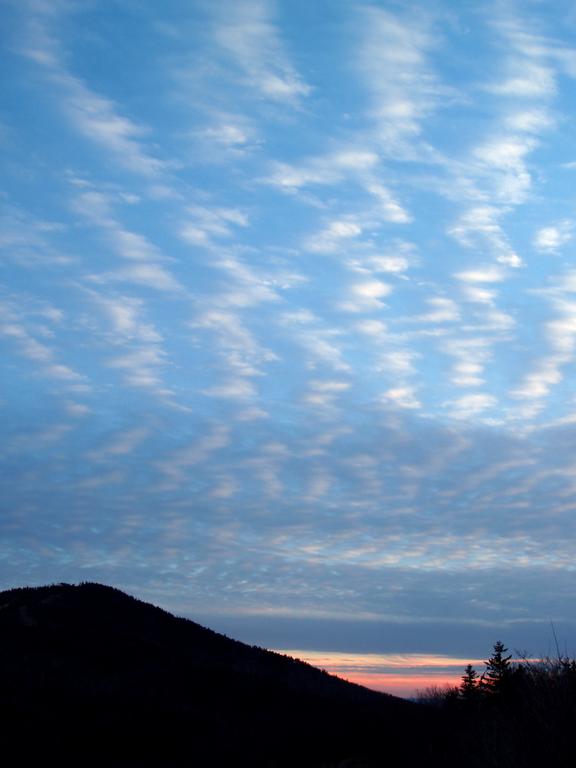 sunset in December over Gunstock Mountain as seen from Mount Rowe in southern New Hampshire