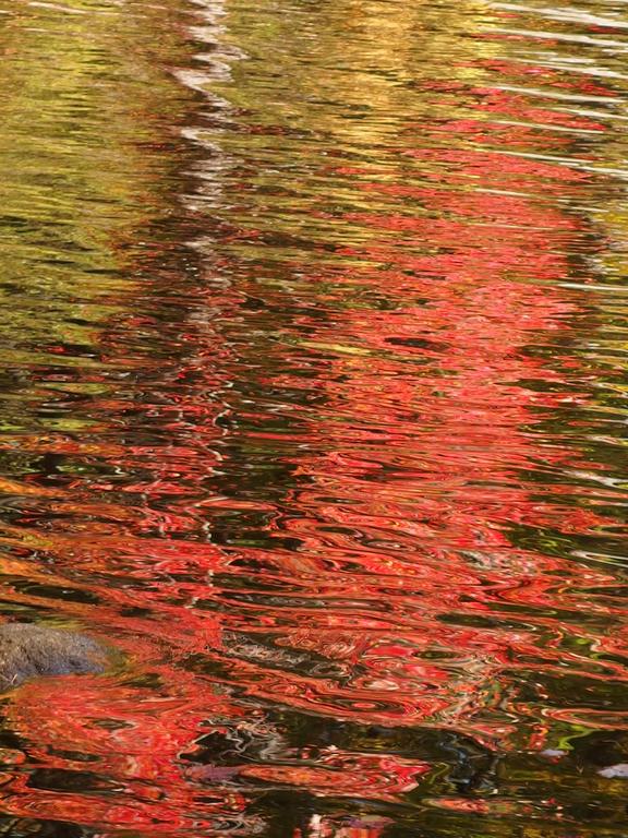 October color reflects off Sunset Lake near Mount Shannon in the Lakes Region of New Hampshire