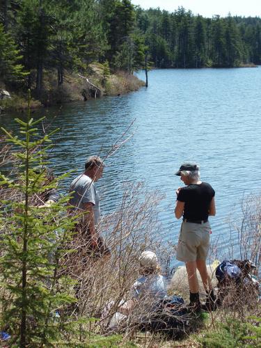 hikers at Round Pond near the Belknap Mountains in New Hampshire