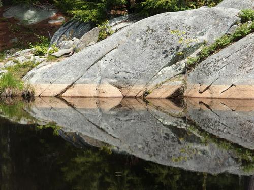 boulder at pond edge near the Sweet Trail in southeastern New Hampshire